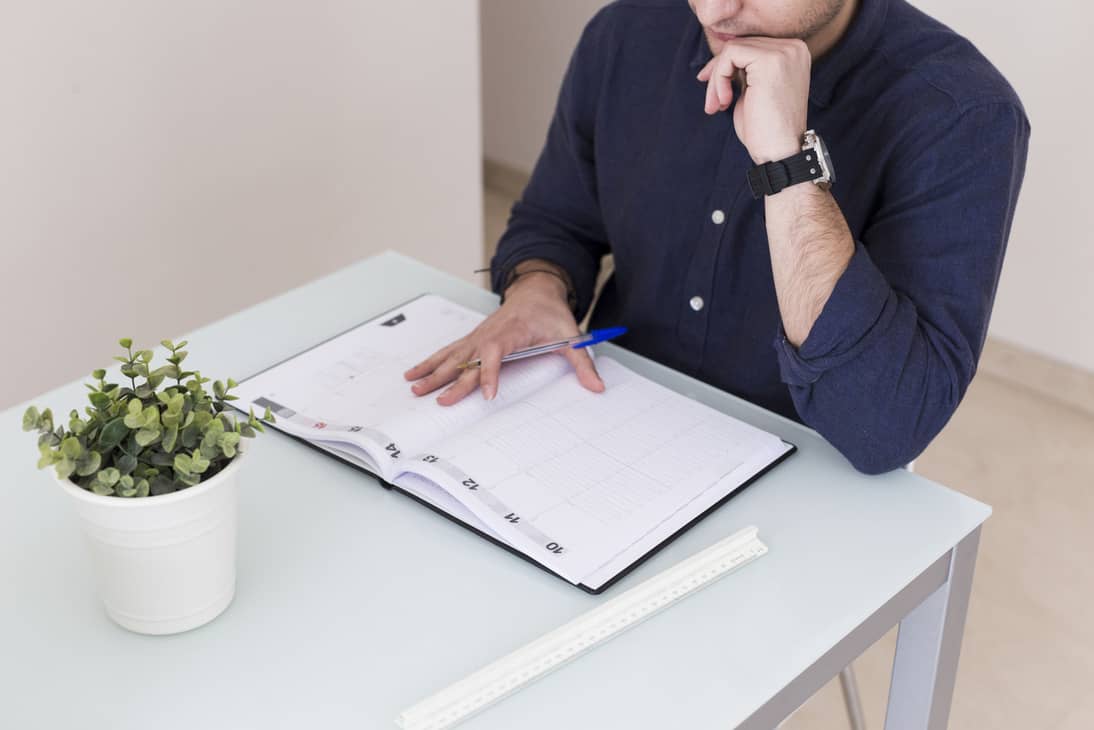crop man reading notes notebook 1 1 1