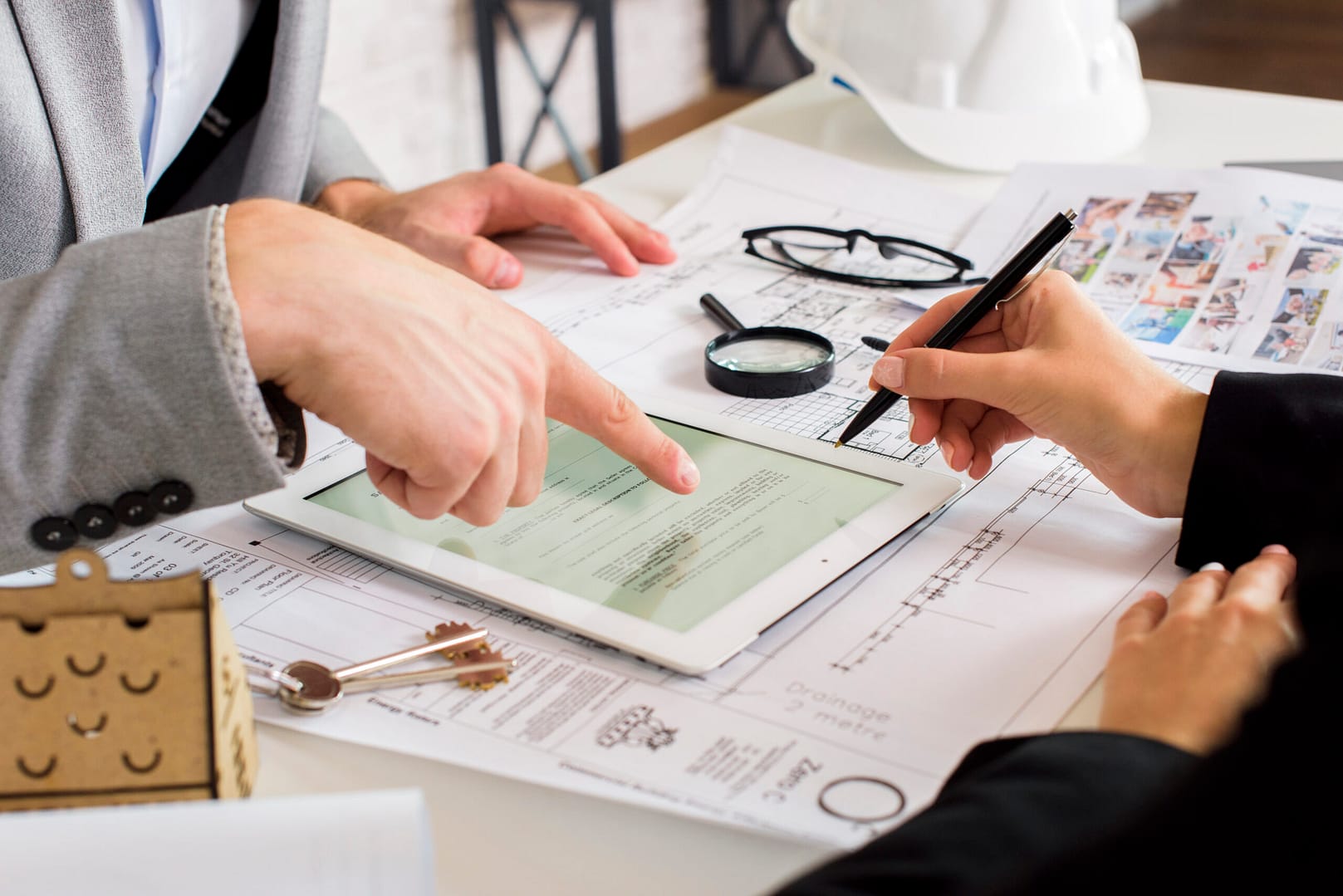 businessmen analyzing business plan tablet 1 scaled