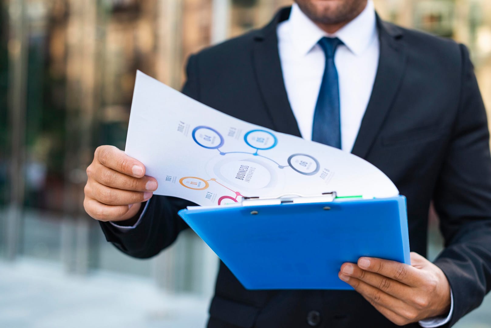 front view business man looking charts scaled