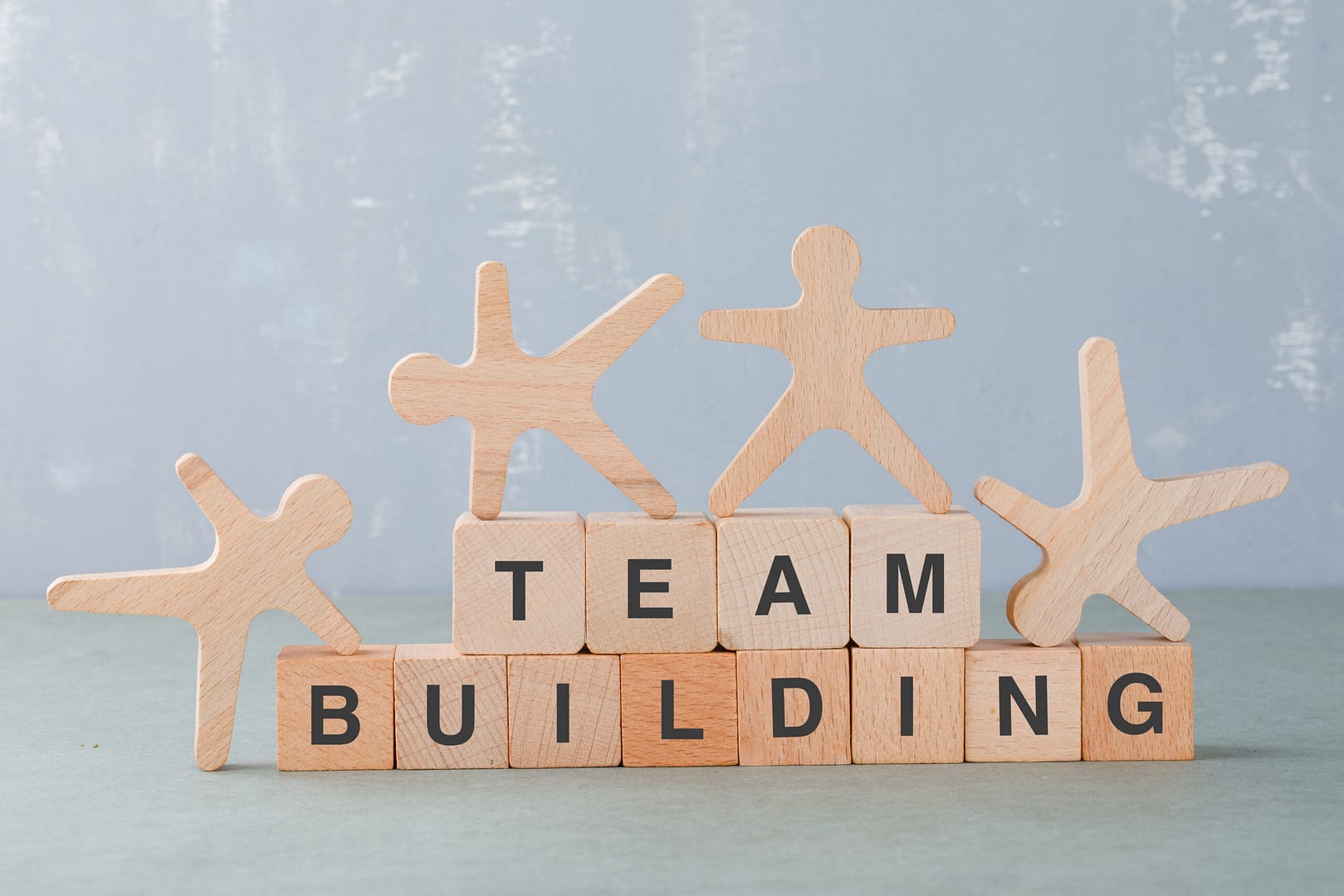 team building concept with wooden blocks wooden human figures it side view scaled