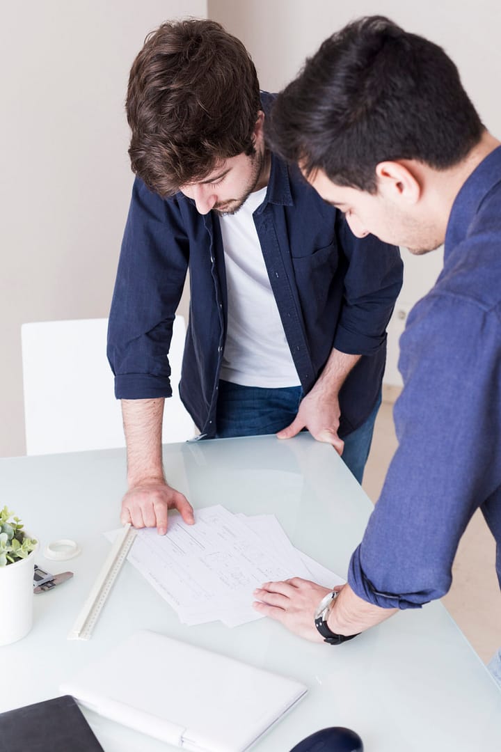 men discussing project office scaled